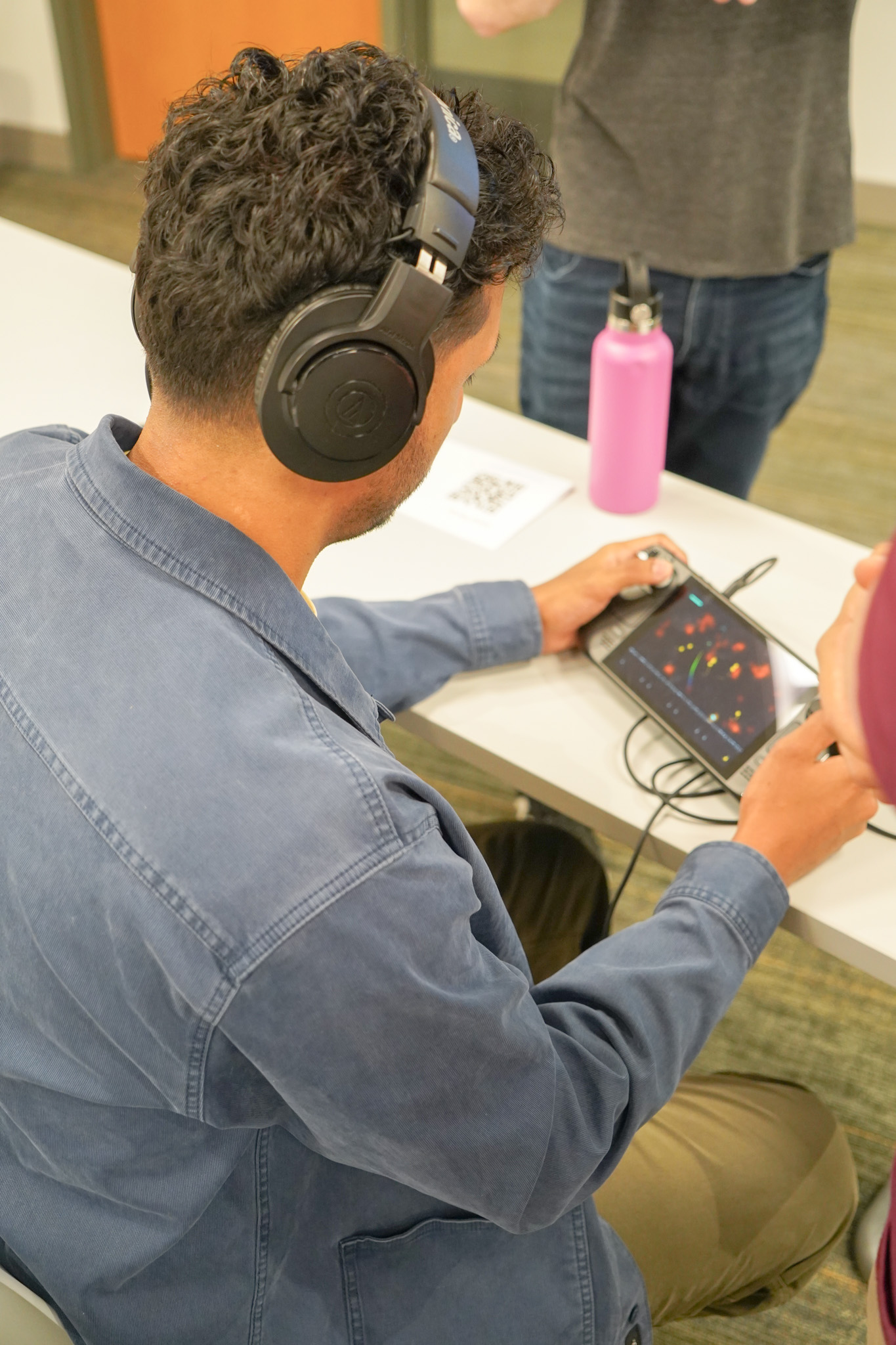 Students gathered closely around a game station
