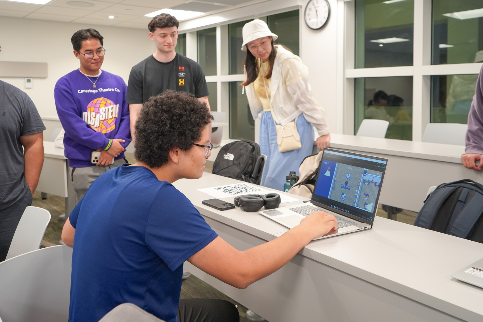 Students explaining a game to players