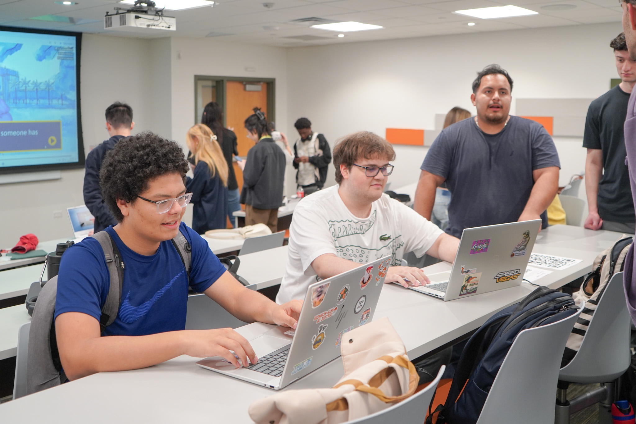 Group clustered around a shared screen
